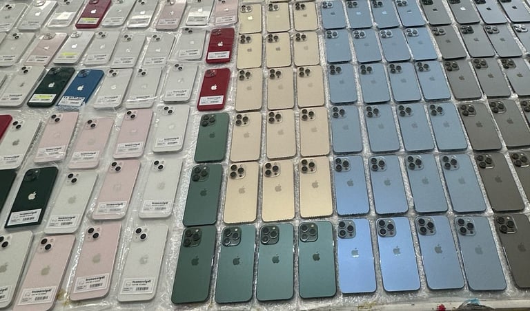 Multiple iPhone models displayed in rows showing various colors including white, pink, green, blue, and gray
